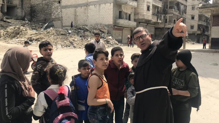 Father Firas Lutfi with children in Aleppo 2020