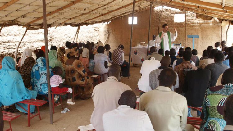 Father Jorge Naranjo, Combonian priest with his community in Sudan